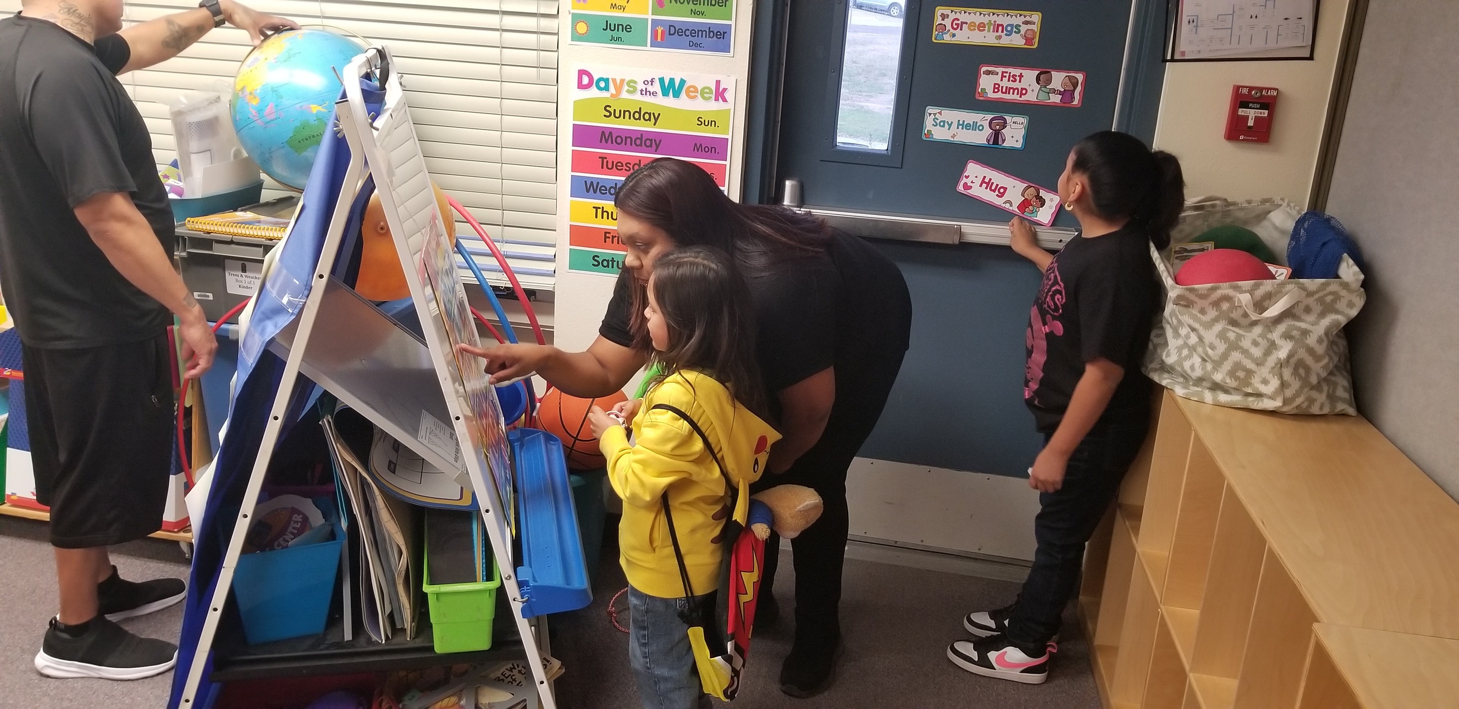 A mom and daughter look at an easel together during Open House