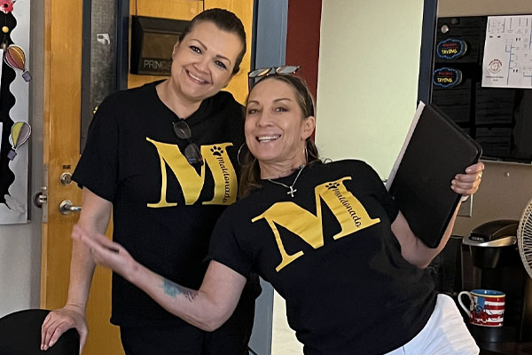 Two staff in Spirit shirts