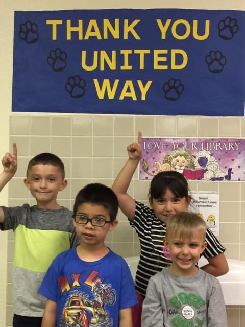 Students posing below a sign that says Thank You United Way